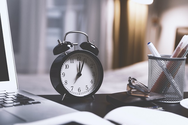 black-twin-bell-alarm-desk-clock-on-table