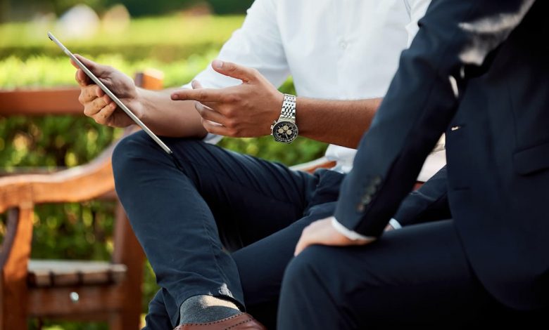 two businessmen having a meeting in the park