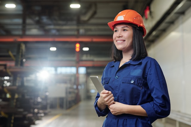 a woman in a helmet at the factory